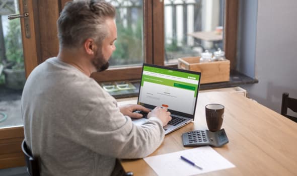 Een man bekijkt zijn klantengedeelte op zijn computer 
