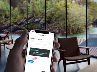 A hand holding a phone showing his Smart App
