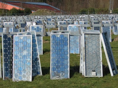Een veld met oude zonnepanelen, klaar om gerecycled te worden 
