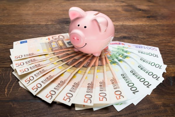 Une tirelire posée sur un éventail d'argent