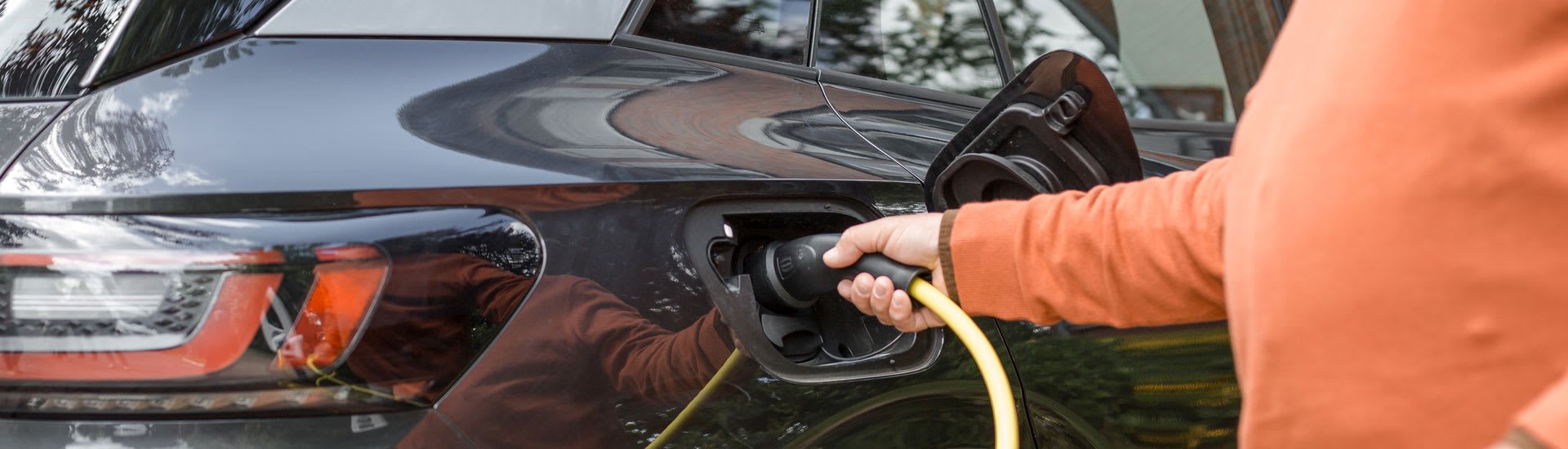 Un homme charge sa voiture noire